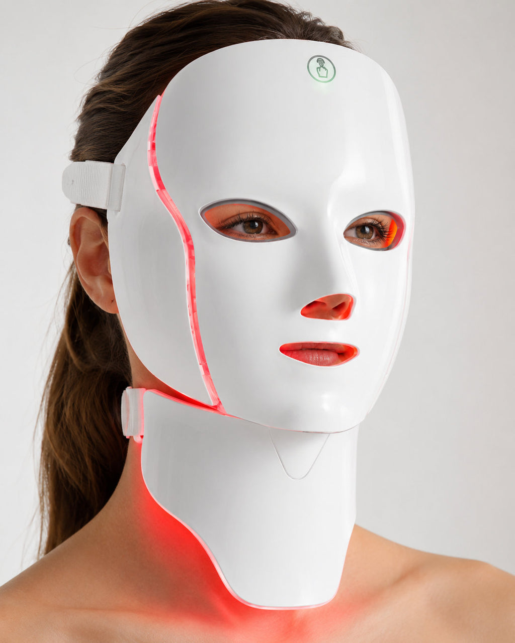 Side view of the LED Longevity Mask showing the hinged neck panel lit red across the throat and jawline