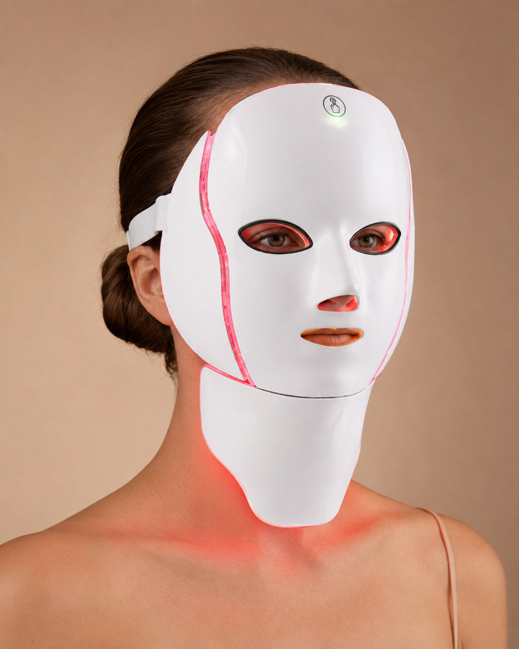 Woman wearing the LED Longevity Mask, red LEDs lighting the cheeks, jawline and neck in one session